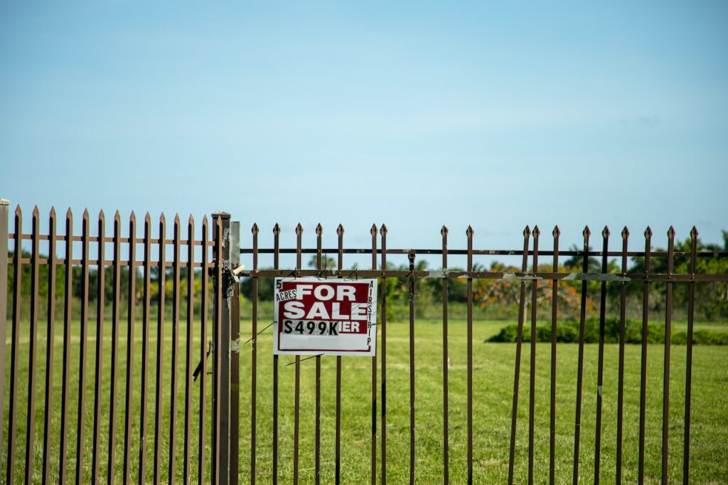 Fenced Plot of Land with For Sale Sign