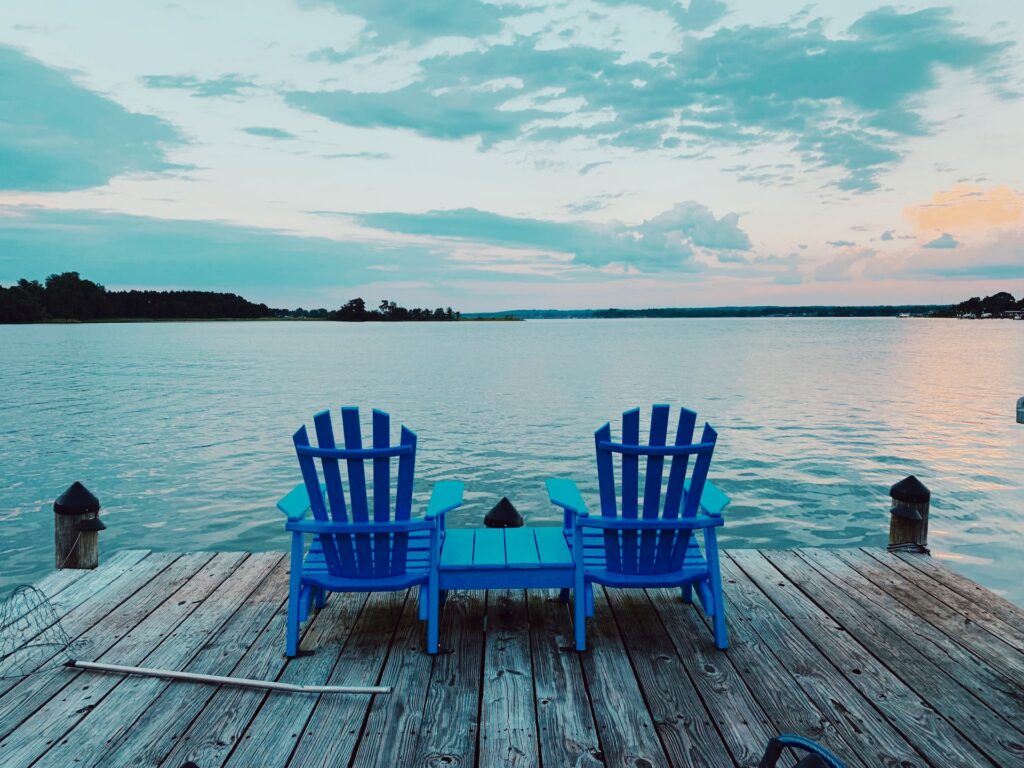 blue wooden chairs at the waterfront