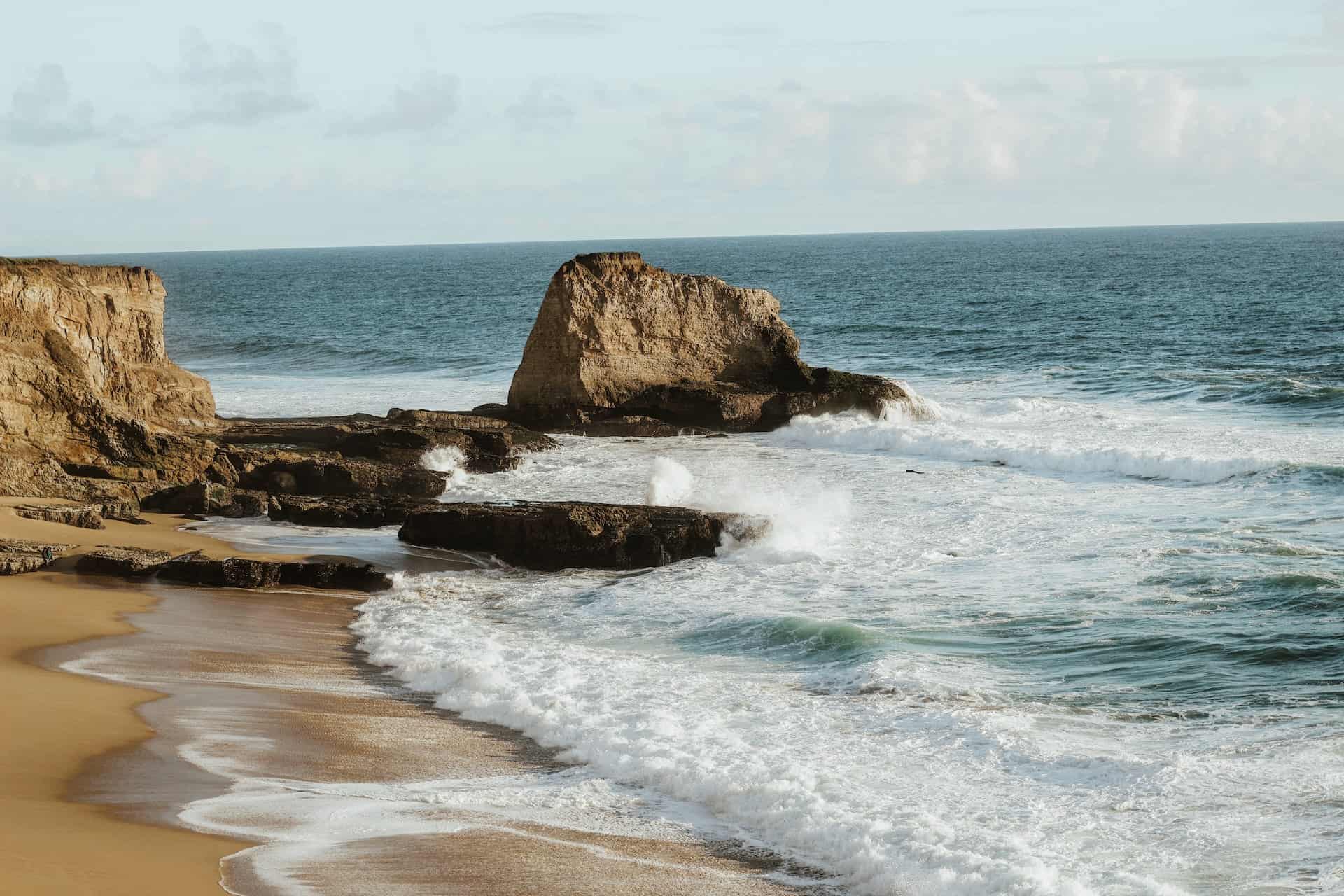 brown rock formation on seashore